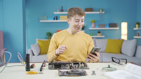 Young-man-doing-research-on-electronic-computer-board.